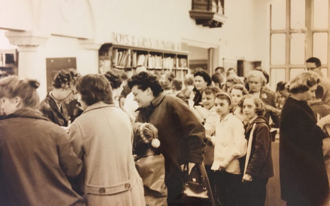 1960 Library patrons check out items for the S.O.S. program