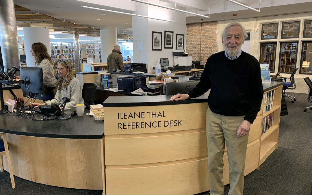 Bruce Thal stands at desk