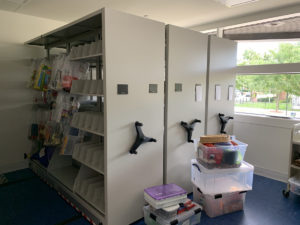 The staff work room includes four collapsible shelving units to hold BPL’s toy collection and program materials.