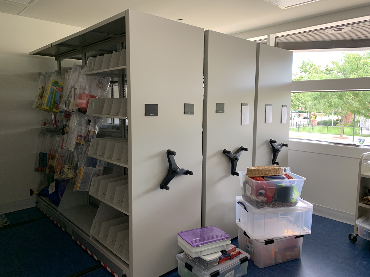 The staff work room includes four collapsible shelving units to hold BPL’s toy collection and program materials.