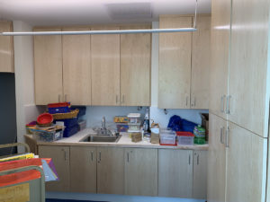 Grams Discovery Room includes a small workspace with a sink, work counter, and cabinets for materials storage.
