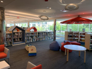 The play area is adjacent to the picture book collection.