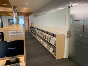 Magazine displays are located behind the New Books shelving.