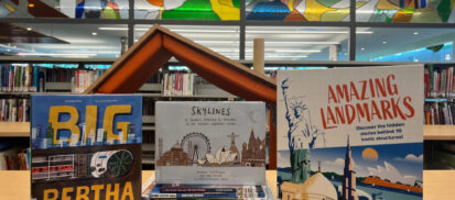 Three books displayed on top of a shelf