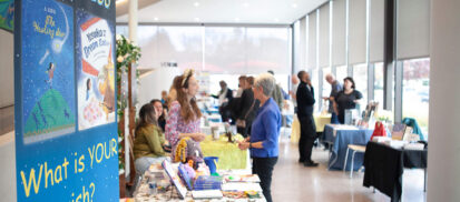A group of indie authors talking to library patrons