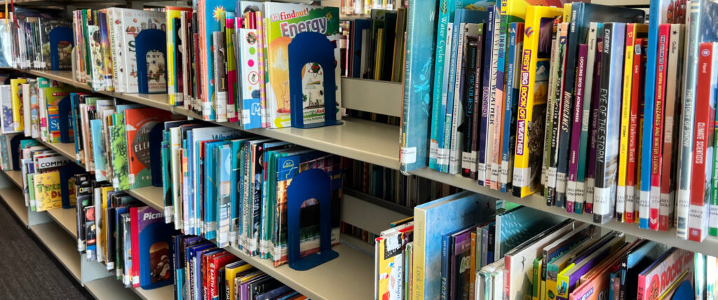 Metal shelves with children's nonfiction books.